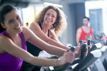 Image showing Group of people running on treadmills