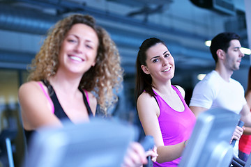 Image showing Group of people running on treadmills