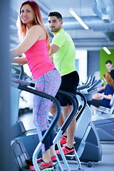 Image showing Group of people running on treadmills