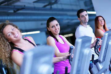 Image showing Group of people running on treadmills