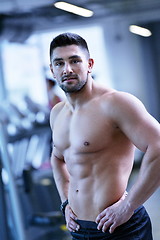 Image showing handsome man exercising at the gym