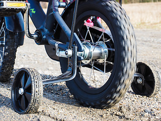 Image showing Bicycle with supporting wheels stuck in loose gravel