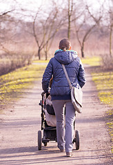 Image showing Young mother with  pram 