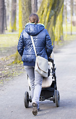 Image showing Young mother with  pram 