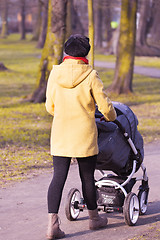 Image showing Young mother with  pram 