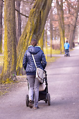 Image showing Young mother with  pram 