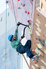 Image showing Man climbs upward on ice climbing competition