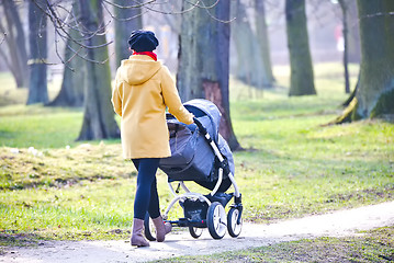 Image showing Young mother with  pram 