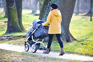 Image showing Young mother with  pram 