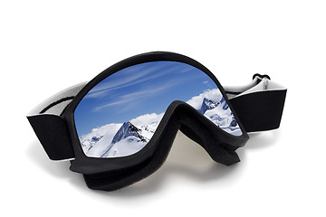 Image showing Ski goggles with reflection of mountains at sunny day