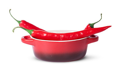 Image showing Three red chili peppers in saucepan