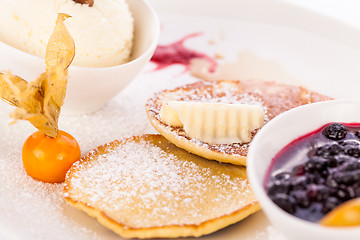 Image showing tasty sweet pancakes with vanilla icecream and topping