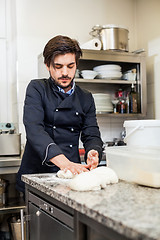 Image showing Chef tossing dough while making pastries