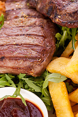 Image showing Platter of mixed meats, salad and French fries