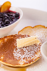 Image showing tasty sweet pancakes with vanilla icecream and topping