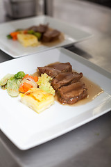 Image showing Chef plating up food in a restaurant