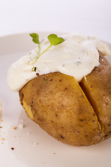 Image showing Baked jacket potato with sour cream sauce