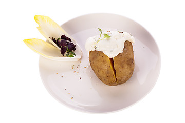 Image showing Baked jacket potato with sour cream sauce