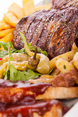 Image showing Platter of mixed meats, salad and French fries