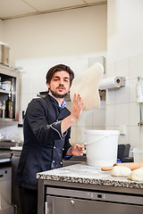 Image showing Chef tossing dough while making pastries