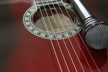 Image showing dark guitar and microphone