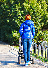 Image showing Young mother with  pram 