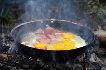Image showing An unusual way of cooking eggs on  fire