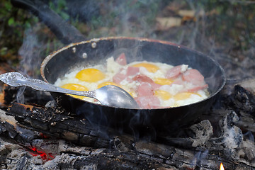 Image showing An unusual way of cooking eggs on  fire