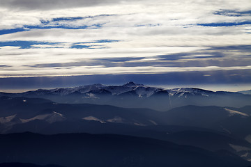 Image showing Silhouettes of cloudy mountains in evening