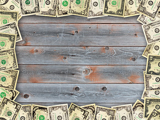 Image showing Frame from the dollars on the wooden board background