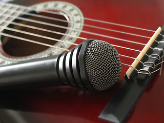 Image showing microphone laying on the guitar