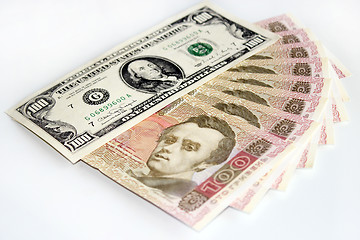 Image showing 100 dollars and grivnas banknotes isolated on dark background