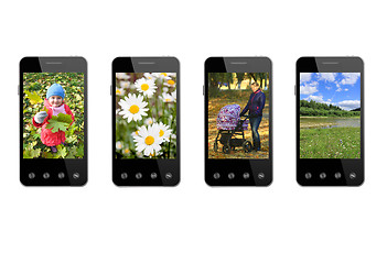 Image showing four smart-phones with colored images isolated