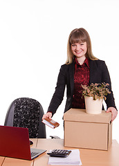 Image showing Adopted at work in office girl puts things out of box