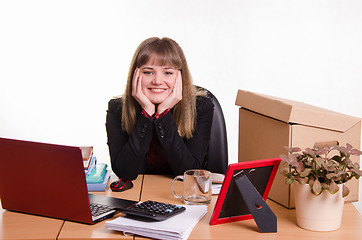 Image showing Pretty teenage girl sitting at office desk