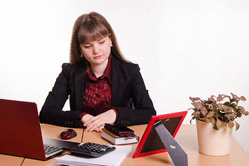 Image showing Detached woman sitting at office table