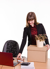 Image showing Adopted at work in office girl puts things out of box