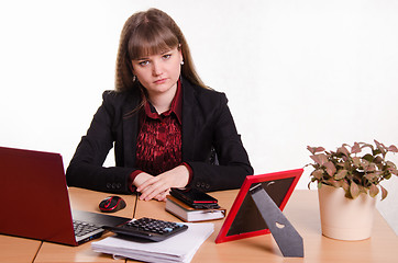 Image showing Sad girl sitting at office desk