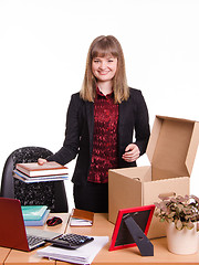 Image showing New employee in the office arranges personal belongings