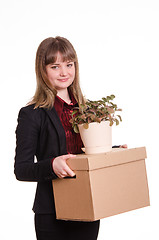 Image showing Portrait of a girl with big box and potted plant in hands