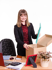 Image showing New employee in office puts his things out of box