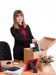 Image showing Adopted in office girl puts her things out of the box