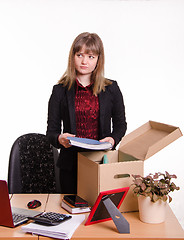 Image showing Dismissed girl collects his belongings in a box