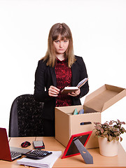 Image showing Dismissed girl puts personal belongings in office