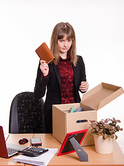 Image showing Dismissed girl office throws a notebook in box