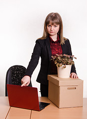 Image showing Dismissed girl in office collects things and closes laptop