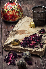 Image showing tea accessories amid frayed books