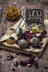 Image showing tea accessories amid frayed books