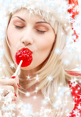 Image showing santa helper with lollipop and snowflakes