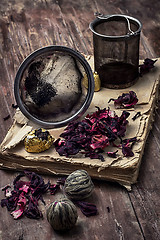 Image showing tea accessories amid frayed books